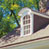 digital edit of a big brick house wth green plant ground cover in front