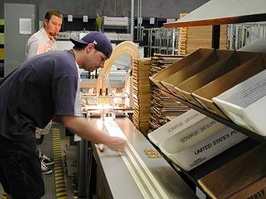 employee working in a mailing area getting an order prepped