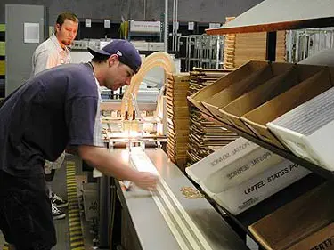 employee working in a mailing area getting an order prepped