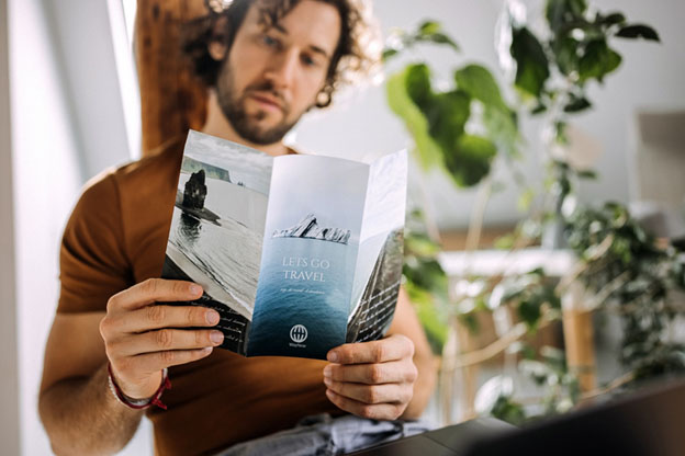 Man Reading a Business Flyer