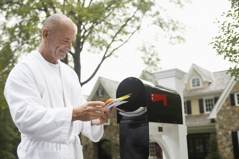 A man finds personalized direct mail in his mailbox