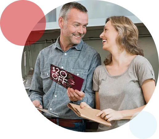Reach New Customers with Modern Postcard A couple reading direct mail and smiling