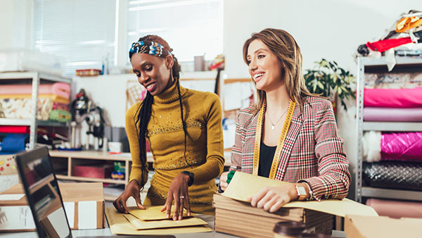 Small business owners at a shop with fabrics
