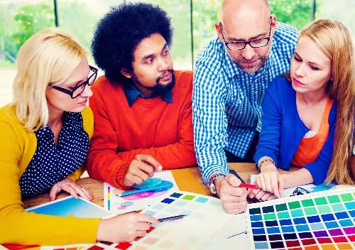 a group of coworkers reviewing color and design for a project