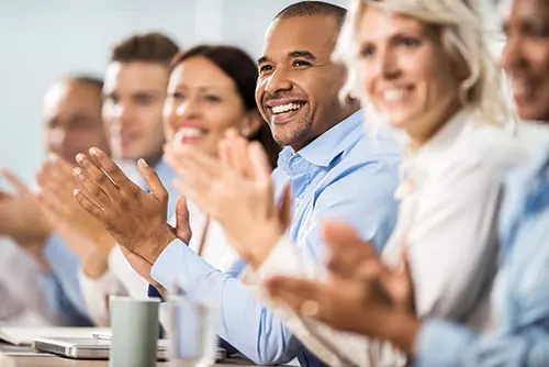 a group of people clapping at a seminar